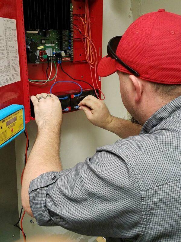 Wilson Fire technician installing hard-wired fire alarm systems