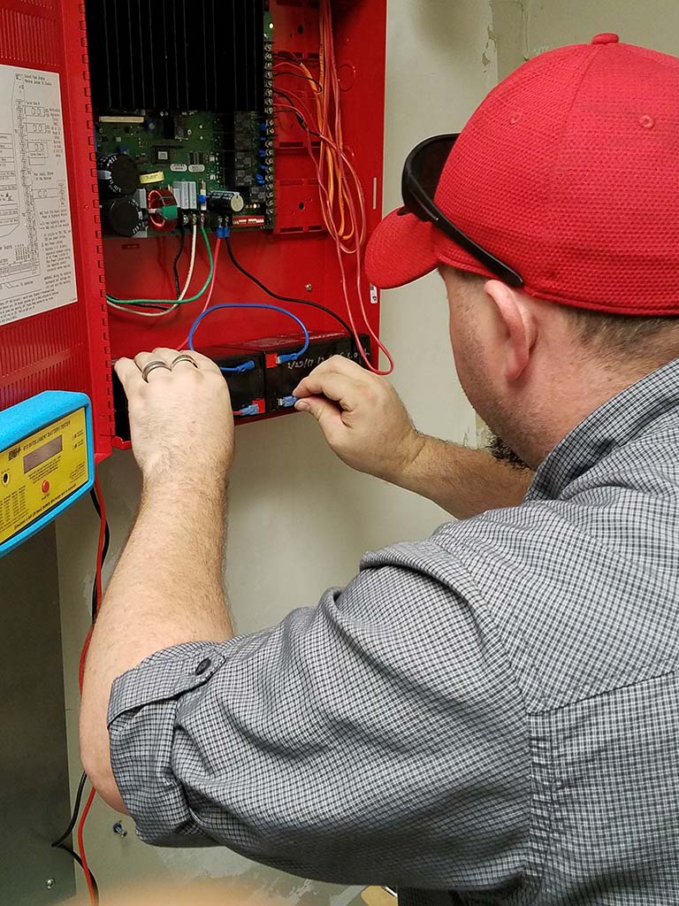 Wilson Fire technician installing hard-wired fire alarm systems