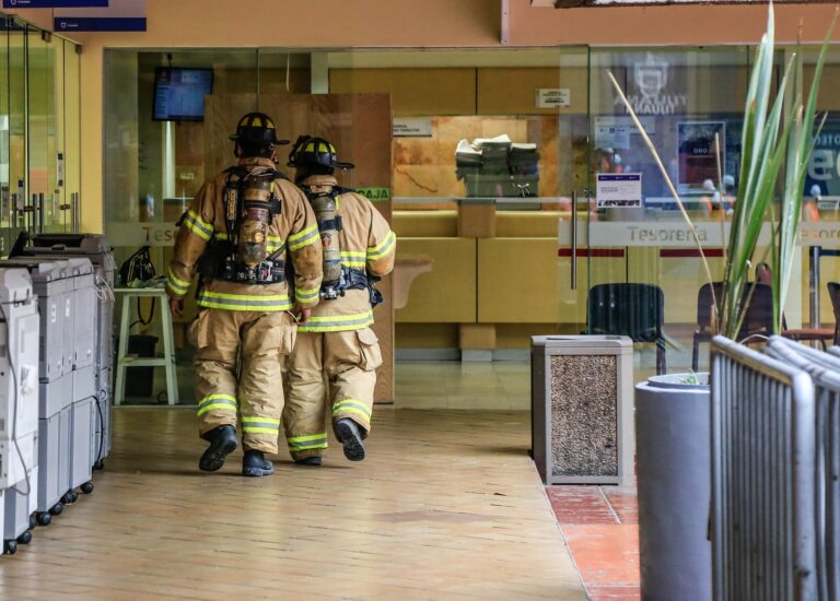 fire men walking through commercial building after life safety solutions enacted