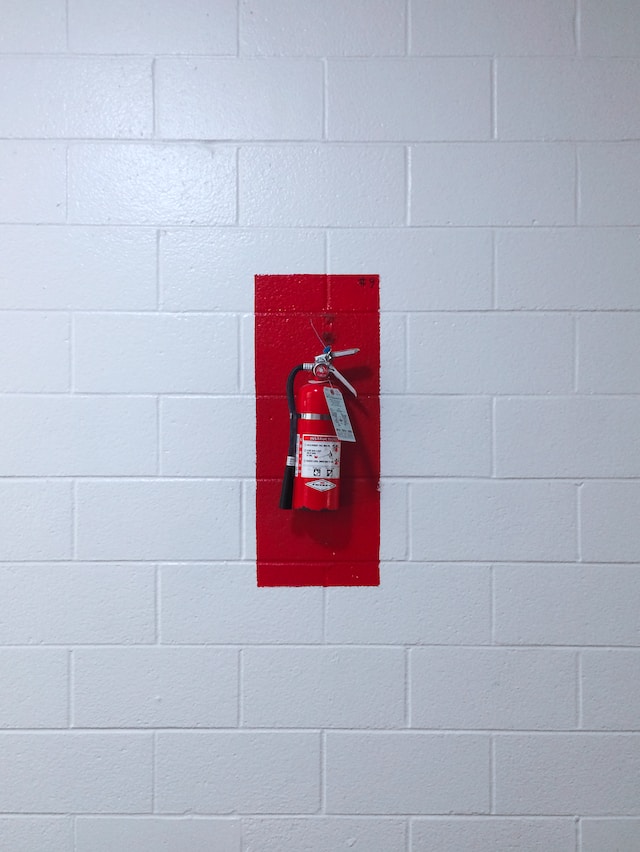 Fire extinguisher on wall for fire suppression in Houston